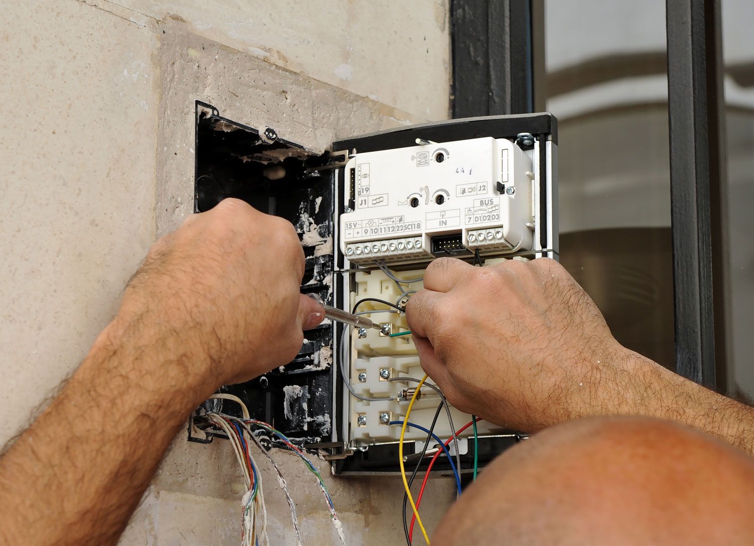 man fixing intercom system
